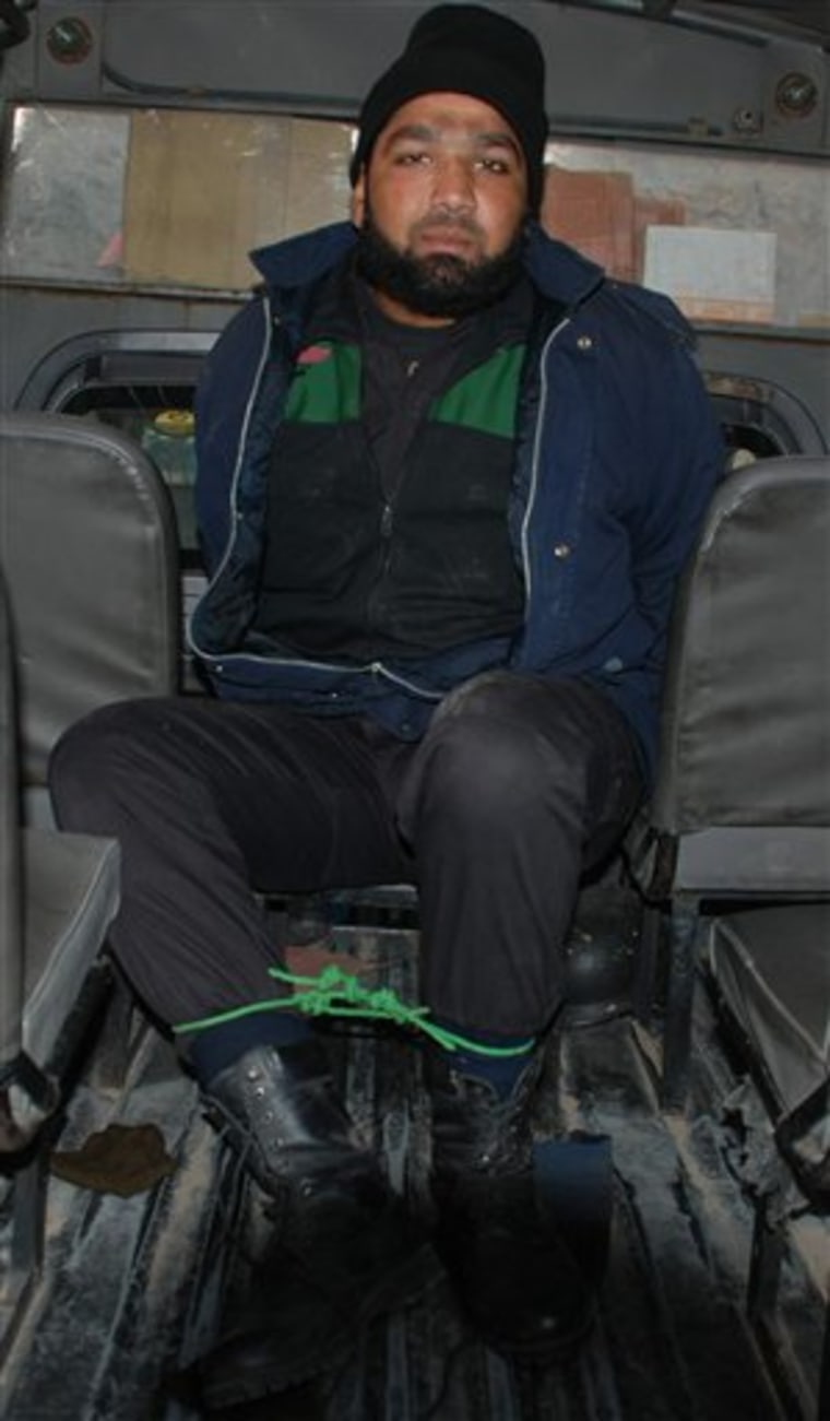 Mumtaz Qadri, who allegedly killed Punjab Governor Salman Taseer, sits in a police van in Islamabad, Pakistan, on Tuesday.